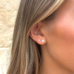 a close up of a person wearing ear piercings