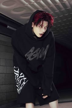 a young man with red hair wearing a black hoodie