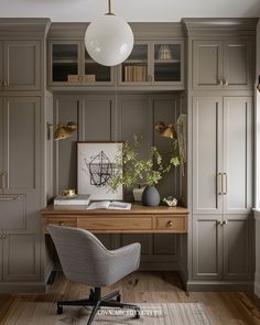 a home office with gray cabinets and a wooden desk