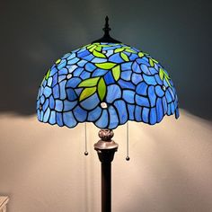 a lamp that is sitting on top of a table next to a dresser and drawers