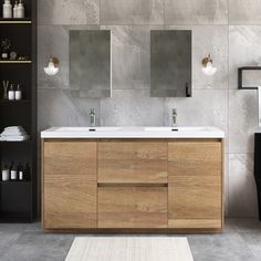 a bathroom with two sinks and mirrors on the wall