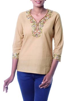 Handloomed cotton in desert tan becomes a blouse by Ritu Agnihotri. With its easy fit three-quarter length sleeves and slits at the hem this tunic goes everywhere in style. Lavish floral motifs are embroidered by hand. Spring Beige Cotton Tunic, Beige Cotton Tunic For Spring, Cotton Kurta With 3/4 Sleeves For Spring, Spring Beige Cotton Kurta, Spring Cotton Kurta In Beige, Traditional Beige Long Sleeve Tunic, Traditional Long Sleeve Beige Tunic, Spring Bohemian Kurta With 3/4 Sleeves, Long Sleeve Cotton Tunic In Beige