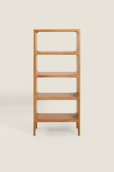 a wooden shelf with three shelves on each side and one shelf in the middle, against a white background