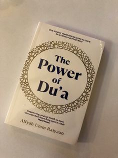 the power of dua book sitting on top of a table