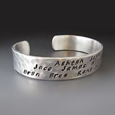 Personalized Mother's Cuff * Children's Names * Hand Stamped Give a one of a kind beautiful handcrafted bracelet with the names of your children or grandchildren. Include your own personal message on the inside. WHAT TO INCLUDE WITH YOUR ORDER: 1. The NAMES you want stamped on the cuff. All names will be stamped on the OUTSIDE of the cuff unless other instructions are provided. ( MAXIMUM OF 10 Names) CUFF DETAILS: * The TOP of the cuff is stamped with your choice of names. This cuff can hold app Moms Bracelet, Stamping Tools, Cuff Detail, Handcrafted Bracelets, Personalized Bracelets, Kid Names, Personalized Custom, Custom Items, Cuff Bracelet