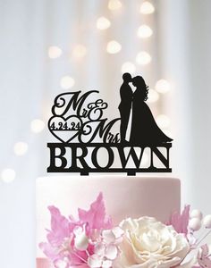 a wedding cake topper that says mr and mrs brown on it with a bride and groom silhouette