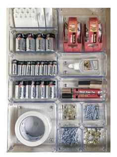 an organized storage drawer filled with batteries and screws