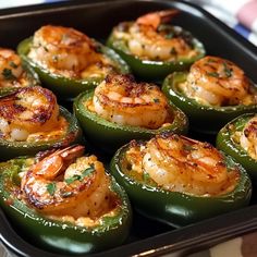 some green peppers with shrimp in them on a table