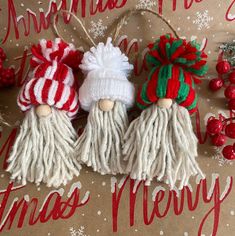 three christmas ornaments are sitting on a table