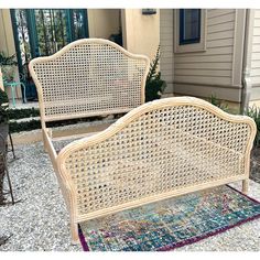 two white wicker beds sitting next to each other on top of a colorful rug