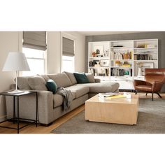 a living room filled with furniture and a book shelf