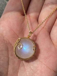 This stunning Natural Flashy Moonstone Sphere Necklace features a smooth, round moonstone pendant that shines with an ethereal flash. Perfect for those who love unique, natural jewelry, this crystal necklace is designed to align with your personal energy while offering a touch of elegance. The white moonstone is known for its calming properties, making it a great stone for emotional balance and healing. Wear it daily or gift it to a loved one as a thoughtful, meaningful present. Each necklace is handmade, ensuring a one-of-a-kind piece. PLEASE CONSIDER -> This is a natural, untreated product of the Earth. Any impurities, cracks, or imperfections (unless otherwise noted) are normal and part of the crystal formation process. All photos and videos are taken in natural and/or room lighting. AB Sphere Necklace, Moonstone Sphere, Personal Energy, Crystal Formations, Natural Jewelry, White Moonstone, Ball Necklace, Moonstone Necklace, Necklace White