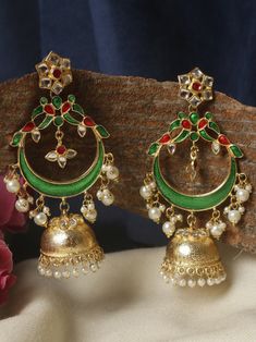 These  green and golden  long jhumkas are an exquisite accessory that exudes elegance and sophistication. Crafted with meticulous attention to detail, these earrings feature a mesmerizing combination of green and golden, creating a stunning contrast that catches the eye. The dark green pearls possess a deep, rich hue reminiscent of lush forests, adding a touch of intrigue and mystery to the overall design.  These earrings boast a long and slender design, gracefully cascading from the earlobes to create an alluring effect. The length adds a sense of drama and sophistication, making them perfect for formal occasions or adding a touch of elegance to everyday outfits. Whether you're attending a gala, a wedding, or a cocktail party, these long jhumkas are  sure to turn heads and elevate your st Jhumkas Earrings, Chandbalis Earrings, Pakistani Jewellery, Jewelry Kundan, Indian Bridal Jewelry Sets, Indian Bridal Jewelry, Pakistani Jewelry, Green Pearls, Bridal Jewellery Indian