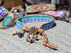 Bead Loom Leather Wrap Bracelet Blue Green Feather Blanket Boho Bracelet Bohemian Jewelry Aerieanna's Wristcraft This is a bead loom leather wrap bracelet made with naturally dyed (veggie) golden brown leather from the USA.  The beads are shades of green and blue. The button is brass plated pewter in a beaded flower design. Glass and stone dangles with feather charm. This bracelet closes at about 7 1/4" and 8 1/4". Feather Blanket, Blanket Boho, Green Feather, Bead Loom, Bracelet Blue, Feather Charms, Boho Bracelet, Leather Wrap Bracelet, Naturally Dyed