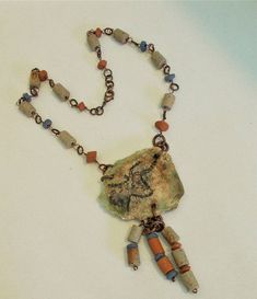 Zoom in and see the lovely textures.  Handmade polymer clay Taurus pendant necklace, clay bead tribal necklace, taurus gift, gift under 100 This handcrafted bull Taurus bead pendant looks ancient, tribal,  primitive. Perfect gift for Taurus birthday.  I crafted this wearable art necklace with copper, clay beads, and a handmade polymer clay focal bead to honor the strong spirit of the bull Taurus from the Lascaux cave paintings. This beaded necklace features handmade un-glazed clay ceramic beads by Leila of India, and my own handmade polymer clay focal bead. Although I recently made this necklace, it has an ancient timeless feel to it. A real statement piece. Gift for a Taurus woman or any strong individual. The colors are cream tans, blue, and rust in the ceramic beads, and a ceramic stone Hand Painted Bohemian Clay Jewelry, Bohemian Hand Painted Clay Jewelry, Bohemian Polymer Clay Pendant Jewelry, Handmade Artisan Polymer Clay Necklaces, Handmade Bohemian Clay Jewelry, Handmade Artisan Polymer Clay Necklace, Bohemian Beaded Polymer Clay Jewelry, Artisan Polymer Clay Pendant Necklace, Beaded Bohemian Polymer Clay Necklaces