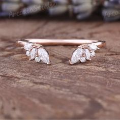 a close up of a pair of earrings on a wooden surface