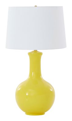 a yellow lamp with a white shade on it