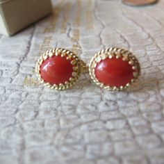 Salmon Red, Sometime Referred to as Sardinian (in color) Gemstone Coral Cab aka Cabochon set in 14k Yellow Textured Gold Pierced Stud Elegant Earrings, Stamped 14k. Everyday Gem Coral & Fine Gold Jewelry, Italian Coral likely (meaning not Asian), good overall condition, the coral has natural markings within the cabochon stones, so they are not flat solid orange, that is how we know they are genuine coral. Perfect size studs with just the right flash of color.  Remember the Victorians put coral on everyone as it was used as protective power against the evil eye and such... 13 MM or 1/2 IN x 11.3 MM or 7/16 IN Stamped 14k  Oval Shape  2.7 grams total weight Studs  They didn't have backs, so I added the ones that fit best, I think they are gold fill Red or Salmon Color  I believe they are Ita Formal Red Jewelry With Matching Earrings, Exquisite Red Earrings For Formal Occasions, Exquisite Red Formal Earrings, Traditional Red Oval Jewelry, Classic Red Gemstone Jewelry, Elegant Red Earrings With Polished Finish, Heirloom Red Jewelry With Cabochon, Red Oval Earrings For Anniversary, 14k Gold Cabochon Earrings Gift