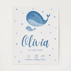 a baby's birth card with a blue whale on the front and white background