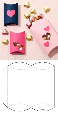 an open book with hearts cut out of it and some gold foil on the pages