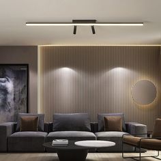 a living room with couches, tables and lamps on the wall in front of it