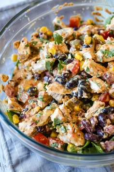 a glass bowl filled with salad and dressing