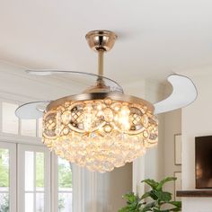 a chandelier hanging from the ceiling in a living room