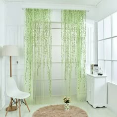 a living room with white furniture and green curtains