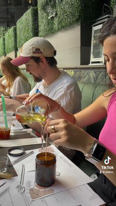 two people sitting at a table with drinks