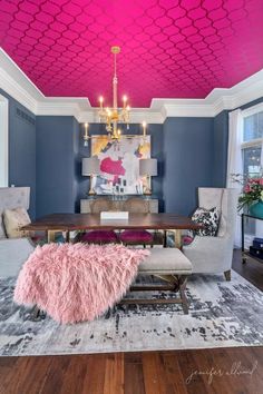 a living room filled with furniture and a pink ceiling painted in the same color as the ceiling