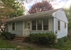 a small blue house with the words before and after on it's front porch