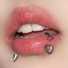 a woman's lips with piercings on the tip of her lip and nose