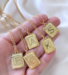 **Each piece in my shop, I personally create and photograph. (All photos are property of The Cord Gallery LLC) Thank you for supporting my small business. Gold Square Letter Medallion Pendant Necklace This stunning Initial Necklace adds a vintage and modern touch to anything you wear it with! Features a 24k gold plated square Medallion Letter Pendant with lots of texture, interest and sheen. Each charm hangs on your choice of chain in the length of your choosing. {Pendants are 1 inch tall (inclu Letter Charm Necklace, Initial Necklaces, Gold Letter Necklace, Letter Pendant Necklace, Gold Medallion, Initial Necklace Gold, Letter Charm, Initial Pendant Necklace, Medallion Necklace