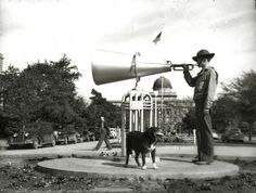 a man with a trumpet and dog in front of a sign that says spirit & team