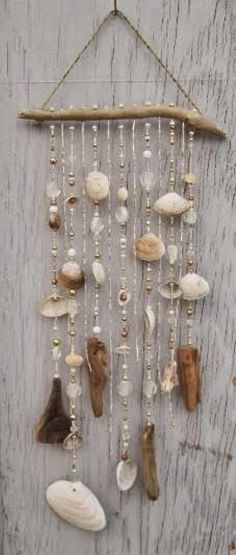 a wall hanging made out of shells and beads