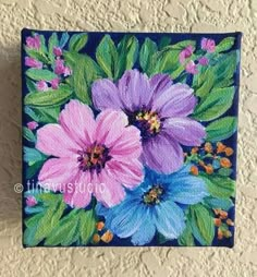 a painting of pink and blue flowers on a wall