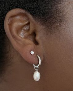 Classy and chic, we’re obsessed with the Willa Gold Pearl Huggie Earrings in White Pearl—and you will be, too! A dainty cultured freshwater pearl dangles from a petite huggie for a lightweight style you’ll pair back with any stack. Metal 14k Gold Over Brass Material White Pearl Closure Ear Post Size 1.8" Outside Diameter, 0.4"L X 0.3"W CharmDue to the one-of-a-kind nature of the medium, exact colors and patterns may vary slightly from the image shown. | Kendra Scott Willa Gold Huggie Earrings in White | Pearl Classy Stud Earrings, Double Piercing Earrings Studs, Silver Earrings Classy, Earring Combos Double, Silver Dainty Earrings, Silver Dangle Pearl Earrings, Classy Jewelry Silver, Prom Jewelry Silver, Earrings Aesthetic Simple