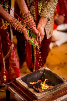 the bride and groom are getting ready to burn their wedding rings