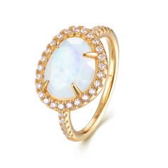 Introducing the Skye Moonstone Ring—a classic piece that features a genuine Rainbow Moonstone, beautifully framed by a halo of sparkling crystals on a pave band. Choose between luxurious 14k Gold Vermeil or elegant Sterling Silver, and let this naturally stunning gemstone captivate you with its unique charm. Each Rainbow Moonstone is handpicked for its individual beauty, ensuring that your ring is truly one-of-a-kind. Details:Gemstone: 9x11mm Genuine Rainbow MoonstoneRing Face (including crystal halo): 14mm x 11.8mmBand Width: 1.8mm Elevate your jewelry collection with the Skye Moonstone Ring—a perfect blend of elegance and enchantment. Country Necklace, Gold Moonstone Ring, Pave Band, Rainbow Moonstone Ring, Sparkling Crystal, Moonstone Ring, Unique Charms, Rainbow Moonstone, Gold Vermeil