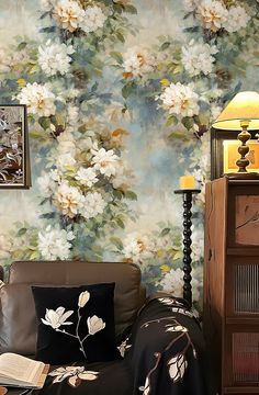 a living room scene with focus on the couch and wall papered with white flowers