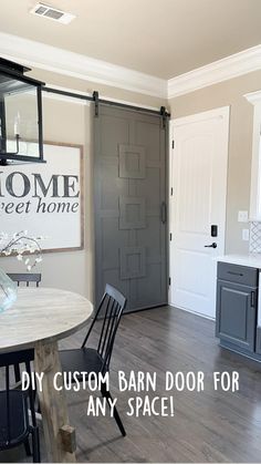 a dining room table and chairs with a sign on the wall above it that says home sweet home