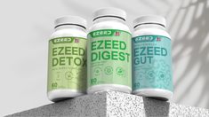 three bottles of eezed detoxist sitting on top of a cement block