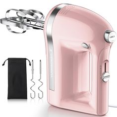 a pink electric hand mixer next to a black bag