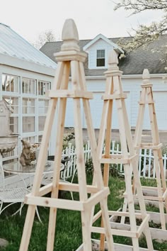 several wooden easels sitting in the grass