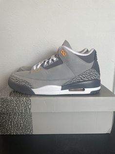 Introducing the Jordan 3 Retro Mid Cool Grey sneakers, perfect for any athletic occasion. These sneakers feature a mid-top silhouette and a stylish gray colorway that will match any outfit. The shoes are made with high-quality materials and the latest technology, ensuring a comfortable fit every time. With a brand as iconic as Jordan, you can't go wrong with these sneakers. They are the perfect addition to any collection and will surely make a statement. Whether you're hitting the gym or just running errands, these sneakers will keep you looking and feeling your best. Jordan 3 Wool, Grey Sneakers, Mid Top, Jordan 3, Latest Technology, Running Errands, Jordan, Comfort Fit, Size 10