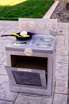 a toy stove sitting on top of a sidewalk