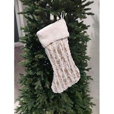 a stocking hanging from the top of a christmas tree