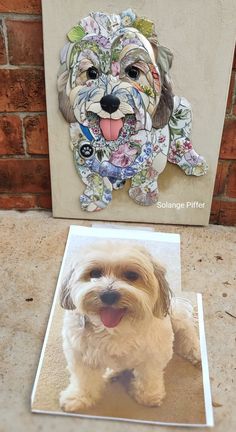 a white dog sitting on top of a tile floor next to a wall with a painting of a dog