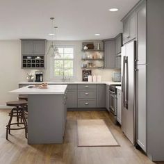 a kitchen with gray cabinets and stainless steel appliances