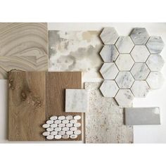 some different types of tile and wood are arranged on the wall, including one with white hexagonal tiles